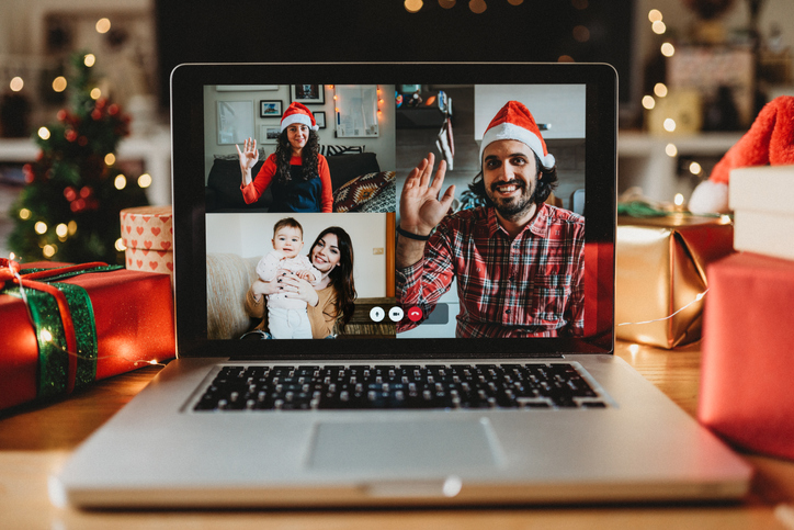 Video call on a laptop screen during Christmas. Celebrating Christmas holidays during Coronavirus Covid-19 pandemic concept. Social distancing concept.